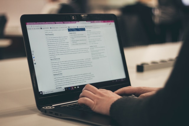 woman writing on laptop